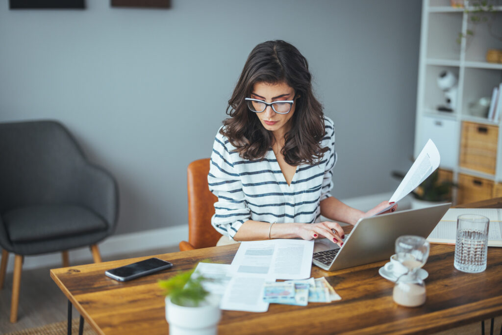 Middle-aged businesswoman organising financial budgets and planning