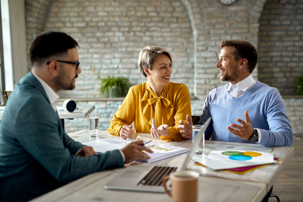 Group of diverse workers discussing tax around office boardroom